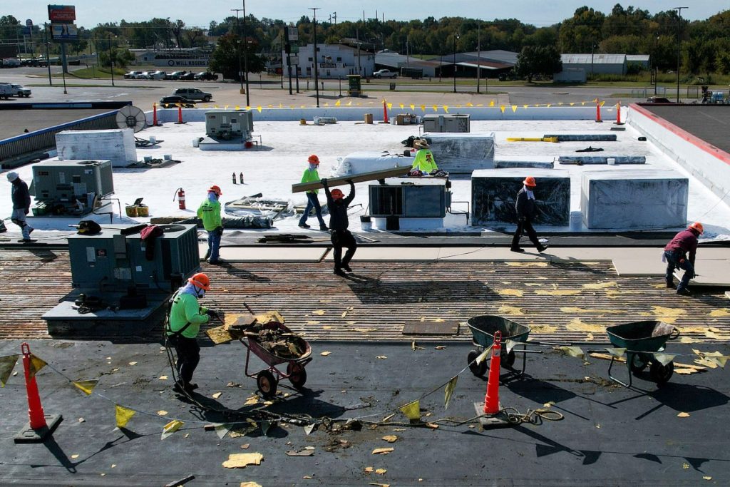 Men working on a commercial roof replacement